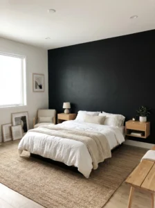Matte black accent wall bedroom with minimalist decor, white bedding, and light wood furniture