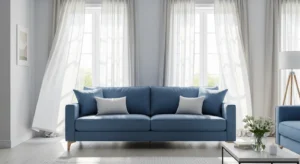 Blue sofa with light curtains creating airy balanced living room