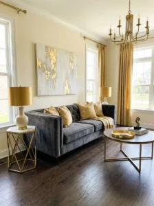 Grey couch styled with gold metallic accents for a luxury look