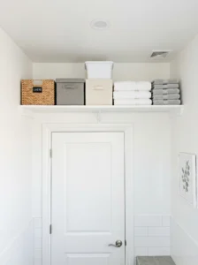 Bathroom shelf above door for extra storage in small bathroom