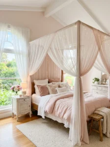 Soft pink canopy bed with sheer fabric in a dreamy bedroom setting