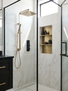 Mixed metal shower fixtures combining gold and black finishes
