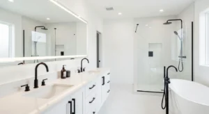 Black fixtures standing out in a white bathroom