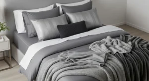 Layered grey bedding adding depth to a modern bedroom