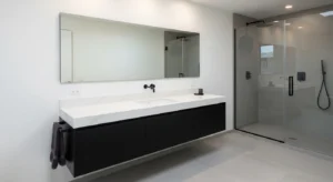 Black vanity creating contrast in a white bathroom