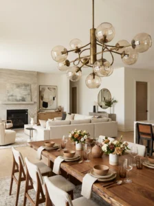 Dining area defined by statement chandelier in open living dining combo