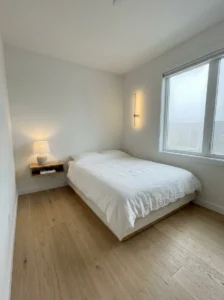 Small bedroom with clear floor space and minimal furniture