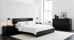 Black furniture creating contrast in a white bedroom