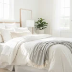 White bedroom with cozy textures and natural light creating a clean and calm space