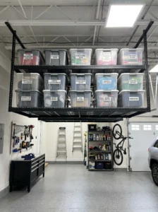Ceiling-mounted garage storage racks holding labeled seasonal storage bins.