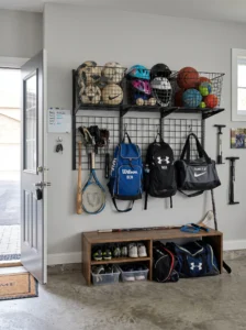 Garage sports equipment organization station with baskets and hooks.