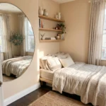 “Bright small bedroom designed to look bigger with mirrors, light colors, and minimal furniture”