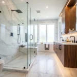 Modern bathroom with frameless glass shower, large-format tiles, floating vanity, and clean contemporary design.
