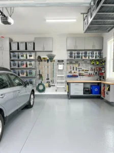 "Organized garage with shelving, labeled storage bins, and neatly stored tools."