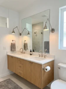 Adjustable swing-arm sconces providing flexible task lighting in a modern bathroom.
