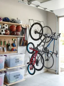 Sports equipment organized vertically on garage wall storage racks.
