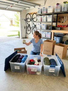 Seasonal garage decluttering process with organized storage bins and sorting system.