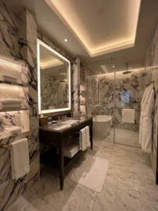 Elegant bathroom with large marble stone slabs and luxurious finishes.