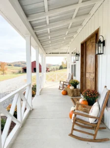 Farmhouse porch featuring decorative X-pattern railings and rustic charm.