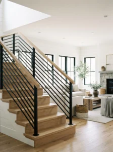 Modern farmhouse staircase with black horizontal metal rails and natural wood accents.