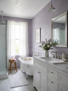 Soft lavender bathroom with calming decor and elegant silver fixtures.