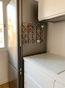 Magnetic spice tins mounted on a refrigerator for small kitchen storage