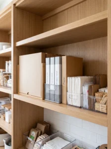 Organized pantry shelf for paper towels, foil and kitchen wraps