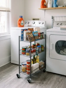 Rolling pantry cart beside washer and dryer for flexible storage