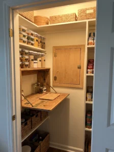 Fold-down shelf providing extra prep space in a pantry