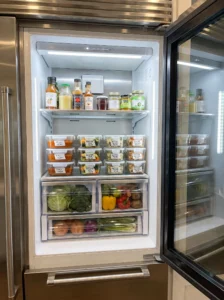Organized refrigerator leftover zone with labeled meal-prep containers