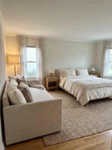 Spacious master bedroom with a daybed providing secondary seating beside the main bed