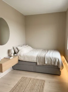 Small master bedroom with a storage bed and minimal surrounding furniture