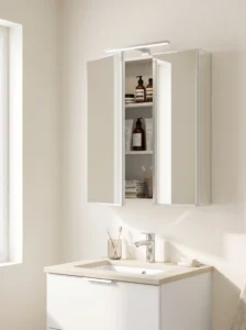 Surface-mounted mirrored medicine cabinet above a small bathroom vanity with hidden toiletry storage and integrated lighting.