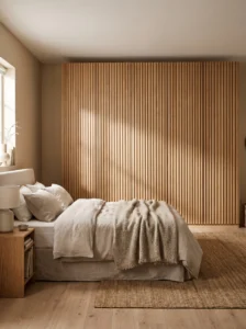 IKEA PAX wardrobe with vertical natural oak fluted door fronts adding warmth, texture, and a custom designer finish.