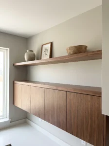 Floating shelf with rotating decor above kitchen cabinets