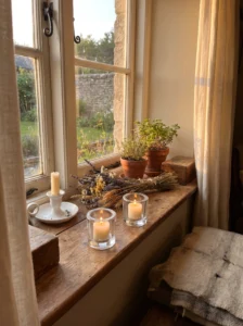 PILFINK clear glass candle holders styled with candles and greenery